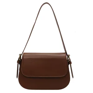 Classic dark brown saddle bag in smooth synthetic leather with flap closure and round bottom
