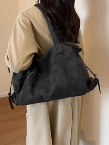 Large dark grey suede tote bag shown on a model wearing a khaki trench coat