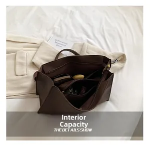 Top-down view showing internal capacity and multi-compartment design of brown leather tote