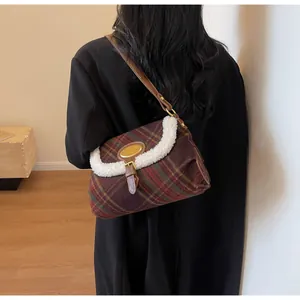 Detail showing vintage plaid shoulder bag with soft white faux fur trim and leather strap