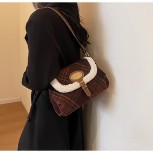 Detail of retro plaid shoulder bag with faux shearling trim and metal buckle accent