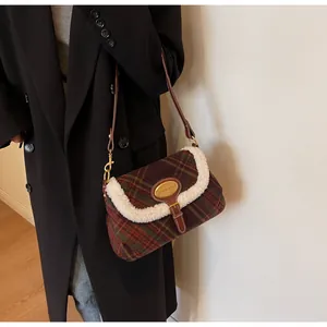 Detail of vintage plaid shoulder bag with wool-like trim and golden brand plaque
