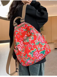 Detail view of ethnic floral backpack side pocket and adjustable khaki straps