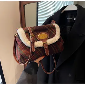 Detail of vintage plaid shoulder bag with green and red check fabric and white faux fur trim