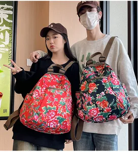 Detail of red and black floral backpack featuring traditional Chinese peony patterns