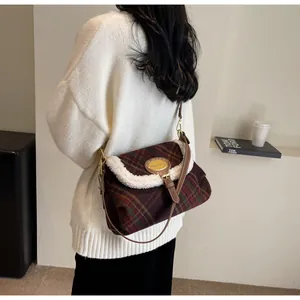 Close-up of retro plaid shoulder bag featuring soft plush trim and gold metal hardware