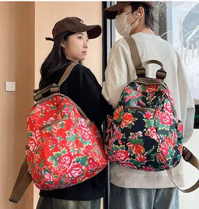Detail of waterproof nylon backpack with traditional red and green peony floral patterns
