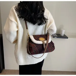 Detail of vintage plaid shoulder bag with wool fabric and white faux shearling trim