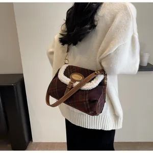 Close-up of retro plaid wool shoulder bag with plush faux fur trim and leather strap