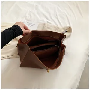 Top view of spacious brown leather tote interior with secure zipper compartment