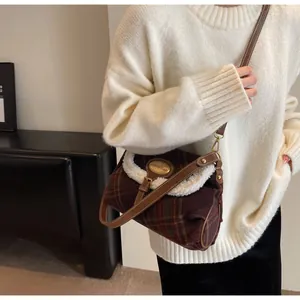 Detail of vintage plaid shoulder bag featuring soft faux shearling trim and leather strap