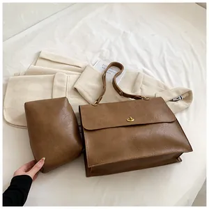 Brown vintage faux leather tote bag set with metal twist lock on a white background
