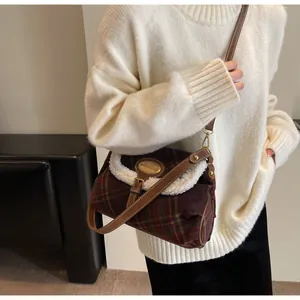 Detail of retro checked shoulder bag with plush fleece trim and brown leather strap