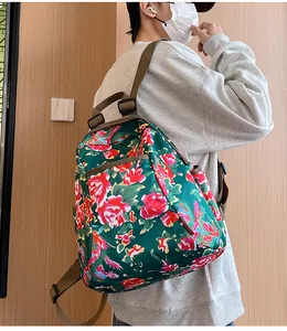 Detailed view of the large capacity ethnic floral backpack with durable brown straps