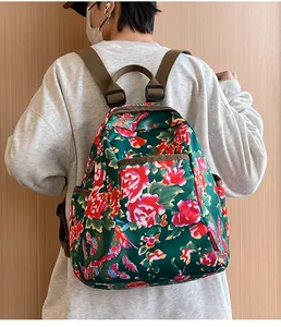 Detail view of ethnic floral backpack with peony pattern and adjustable brown straps