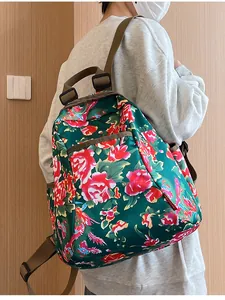 Close-up of backpack side showing red floral pattern and side brand label detail