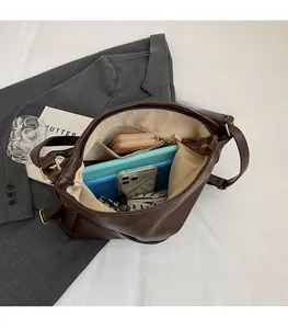 Interior view showing the large capacity and functional compartments of a brown tote bag