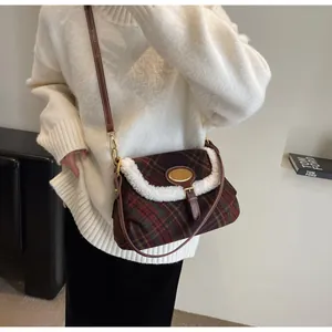 Close-up of retro plaid underarm bag with white faux fur trim and brown leather detail