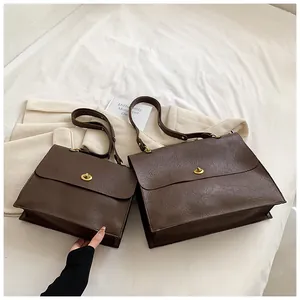 Comparison of large and small vintage brown leather tote bags with gold twist locks