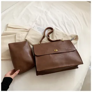 Detail of dark brown vintage faux leather handbag set with adjustable shoulder strap