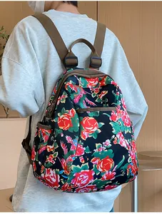 Detail view of ethnic floral backpack with red rose patterns and durable nylon fabric