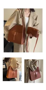 Detailed view of the brown leather tote set with an elephant patch and inner pouch