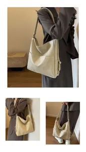Detail of cream leather tote bag featuring front pocket and adjustable shoulder strap