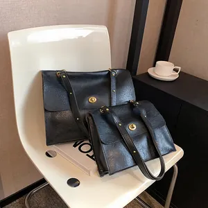 Set of black vintage leather shoulder bags with gold turn-lock and rivet straps