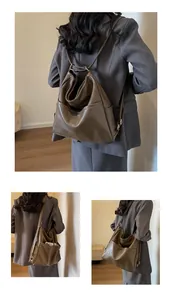 Macro shot of brown PU leather bucket bag showing retro texture and adjustable straps
