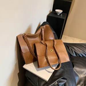 Retro brown leather tote and handbag set with metal twist-lock and rivet details