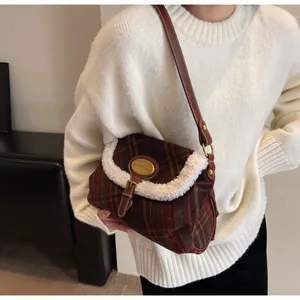 Detail of vintage plaid shoulder bag with wool trim and classic tartan pattern for winter