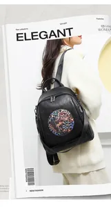 Detail shot of black PU leather backpack featuring a colorful ethnic elephant patch