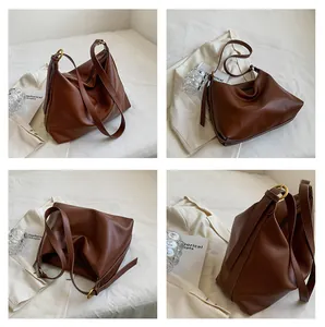 Detailed views of a large dark brown hobo bag with adjustable strap and metallic rings