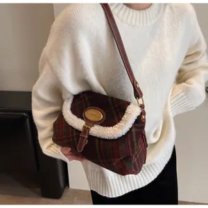 Detail of vintage plaid shoulder bag with white faux fur trim and gold buckle on a model