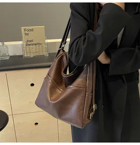 Macro view of textured brown faux leather material and stitching on large tote bag