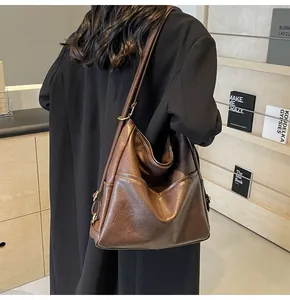 Detailed view of deep brown large capacity faux leather shoulder bag with vintage texture