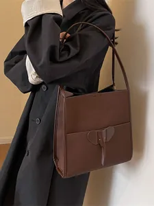 Retro dark brown leather tote bag with unique elephant design and long shoulder straps