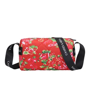 Quilted floral puffer cylinder crossbody bag with traditional peony pattern and wide strap