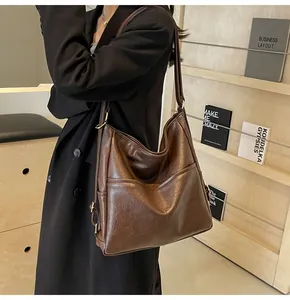 Detailed view of brown large capacity tote bag with vintage synthetic leather texture