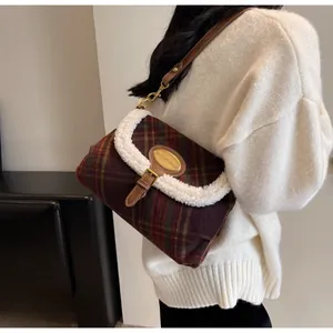 Detail of retro plaid underarm bag featuring wool trim and adjustable leather strap