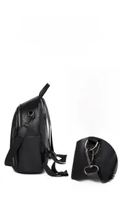 Detail of adjustable straps and silver metal hooks on a black leather backpack