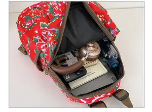 Internal view of a floral backpack showing storage space for laptop and accessories