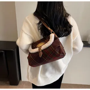 Retro brown plaid crossbody bag with fuzzy sherpa trim worn over a white sweater