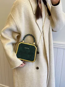 Elegant emerald green octagonal crossbody bag with gold metal frame and chain strap