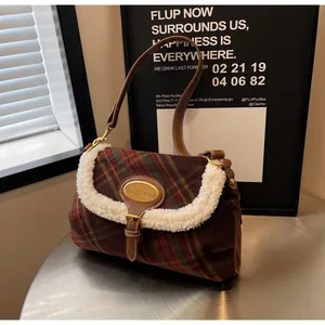 Detail of plaid wool shoulder bag with shearling trim and metallic oval logo plaque