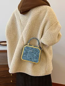 Octagonal blue marble texture box bag with gold chain and woven handle on model
