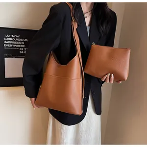 Detail view of large brown pebble leather hobo bag with matching zippered pouch set