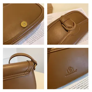 Détails du sac en cuir marron avec boucle magnétique dorée et coutures fines en gros plan