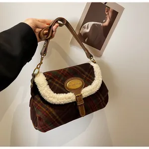 Detail of retro plaid underarm bag with cream faux fur trim and brown leather strap
