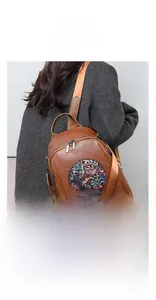 Detail of trendy large capacity brown backpack with elephant pattern and zipper features